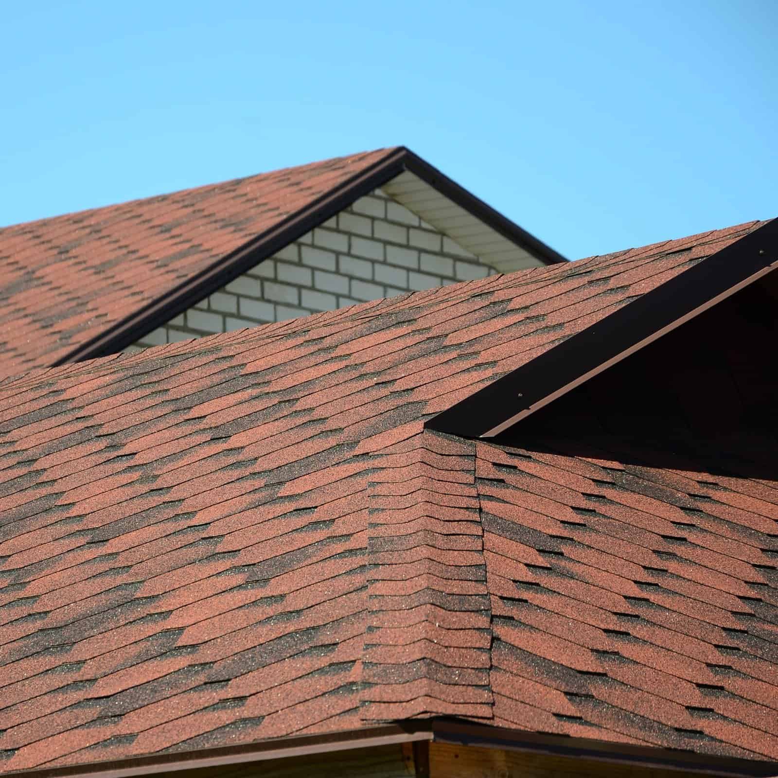 Highly durable asphalt roofing shingles on a residential house.